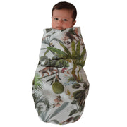 Baby Wrapped in the Jungle Swaddle by The Swaddle Society