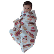Baby Wrapped in the Patisserie Swaddle by The Swaddle Society